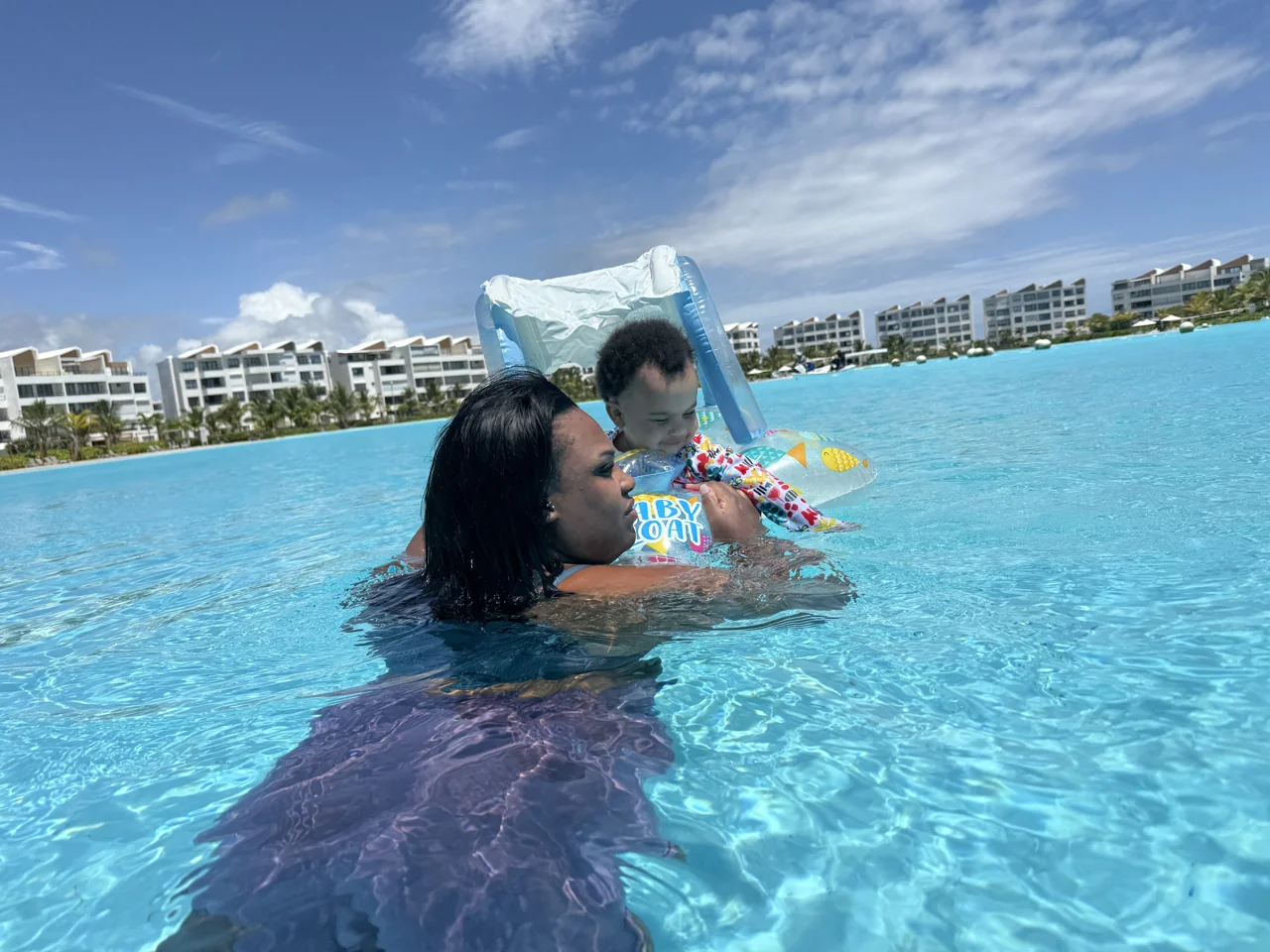 Amia playing with her baby in the pool